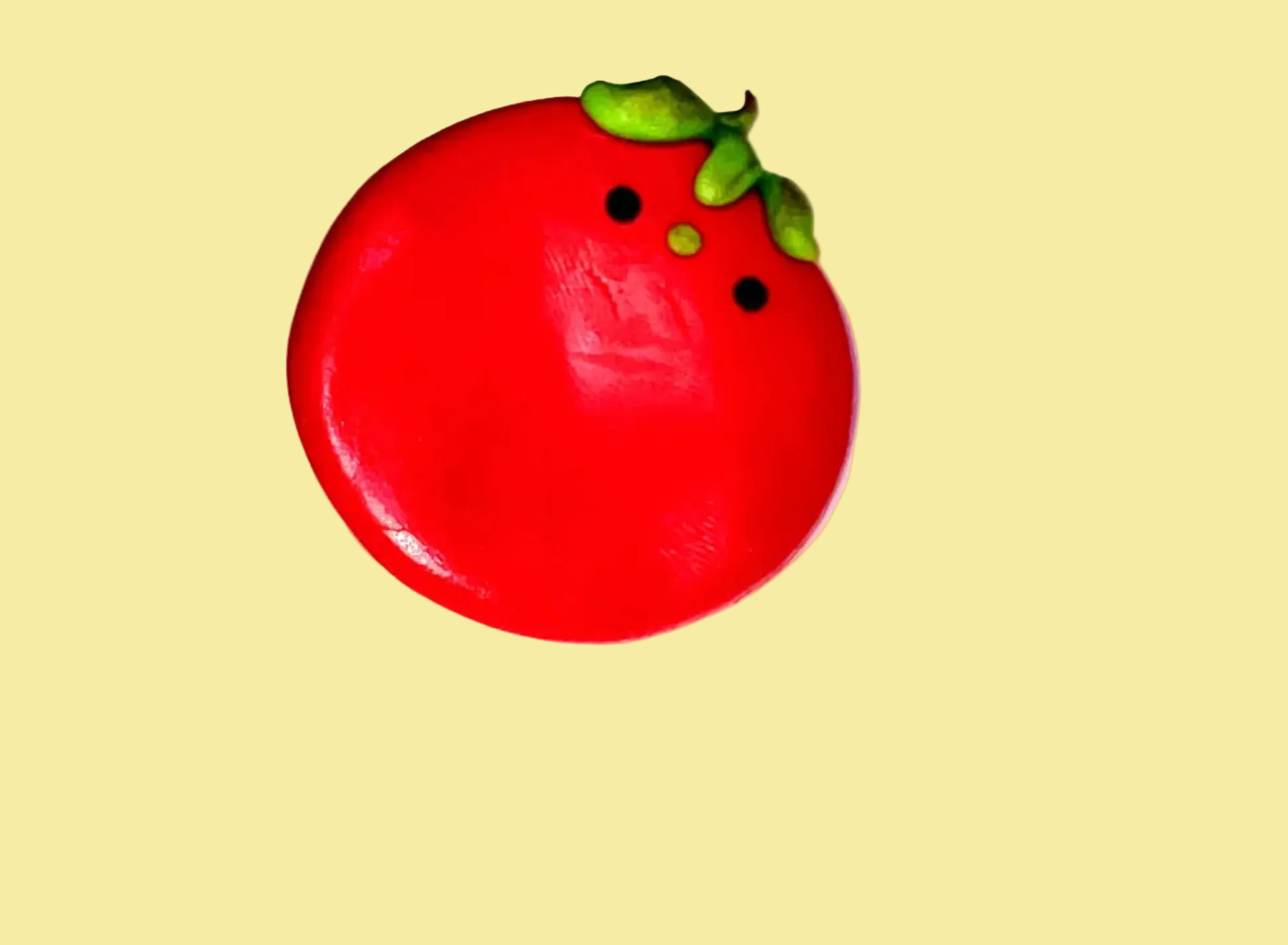 Red circular object with green accents on a white background
